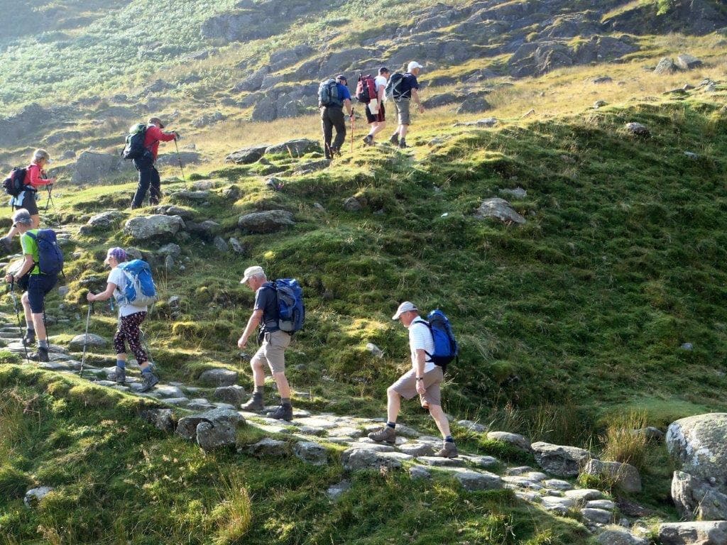 Line of hillwalkers climbing the steps up Torc Mountain